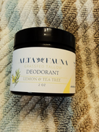 An amber glass jar of Alta Fauna Deodorant in Lemon & Tea Tree scent, sitting on a bathroom towel.
