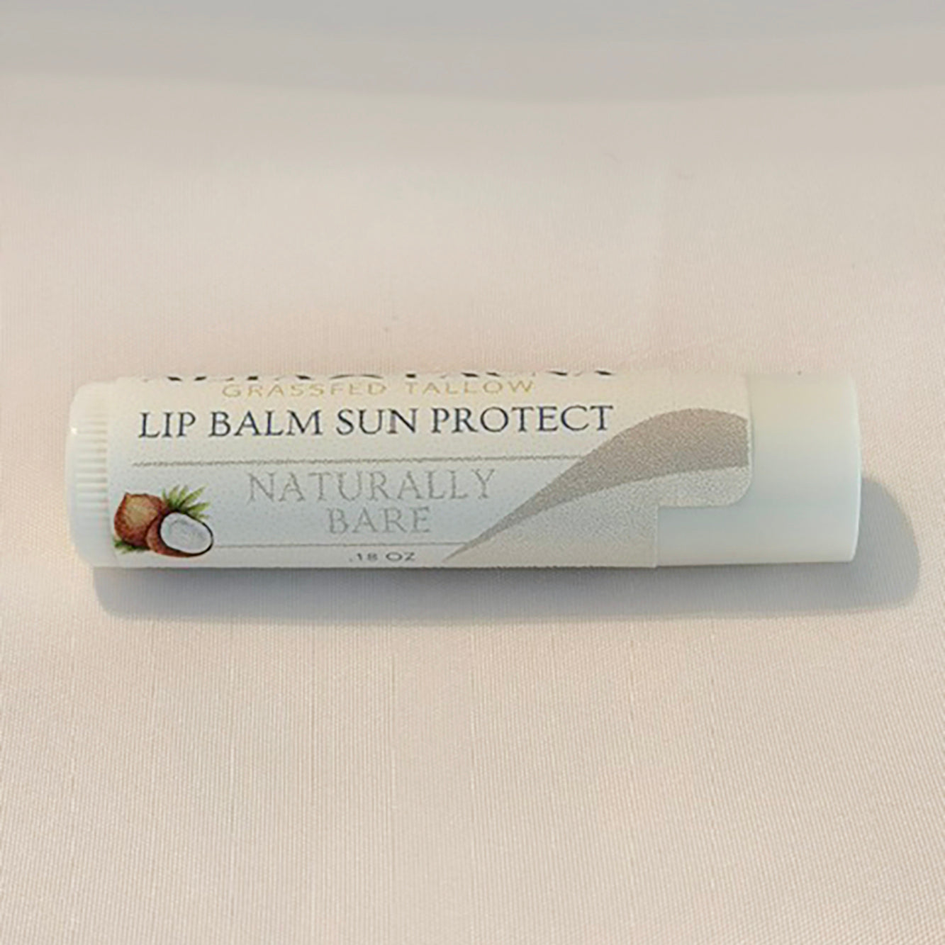 Alta Fauna Naturally Bare (unscented) Lip Balms with Sun Protect on white background.  Texture of lip balm shown. 