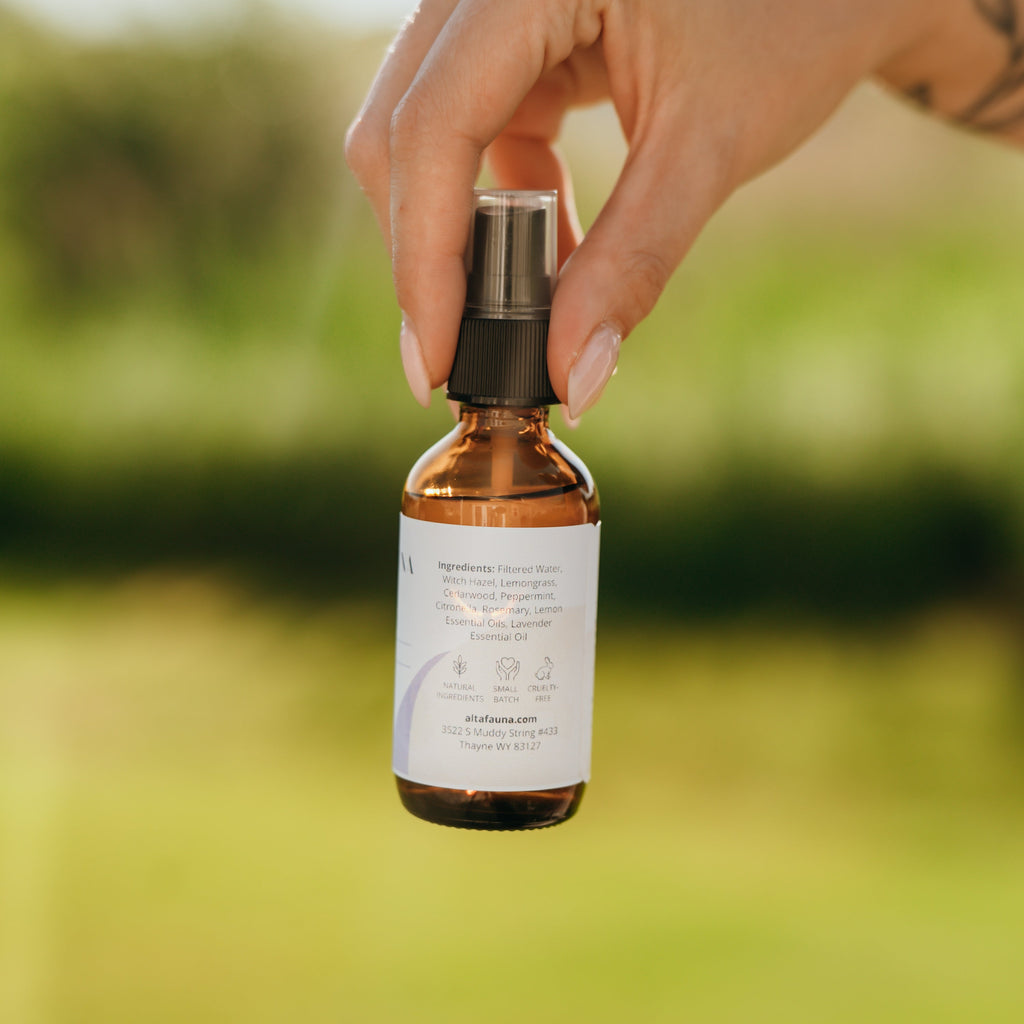 Alta Fauna Bug Guard being held by a hand showing the ingredients: witch hazel and essential oils 