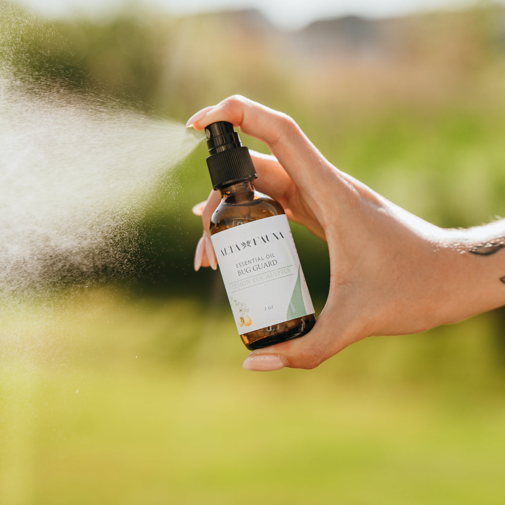 Alta Fauna Bug Guard natural insect repellent spray made with witch hazel and essential oils being sprayed outside, a fine mist is visible