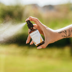 Alta Fauna Bug Guard natural insect repellent spray made with witch hazel and essential oils being sprayed outside, a fine mist is visible