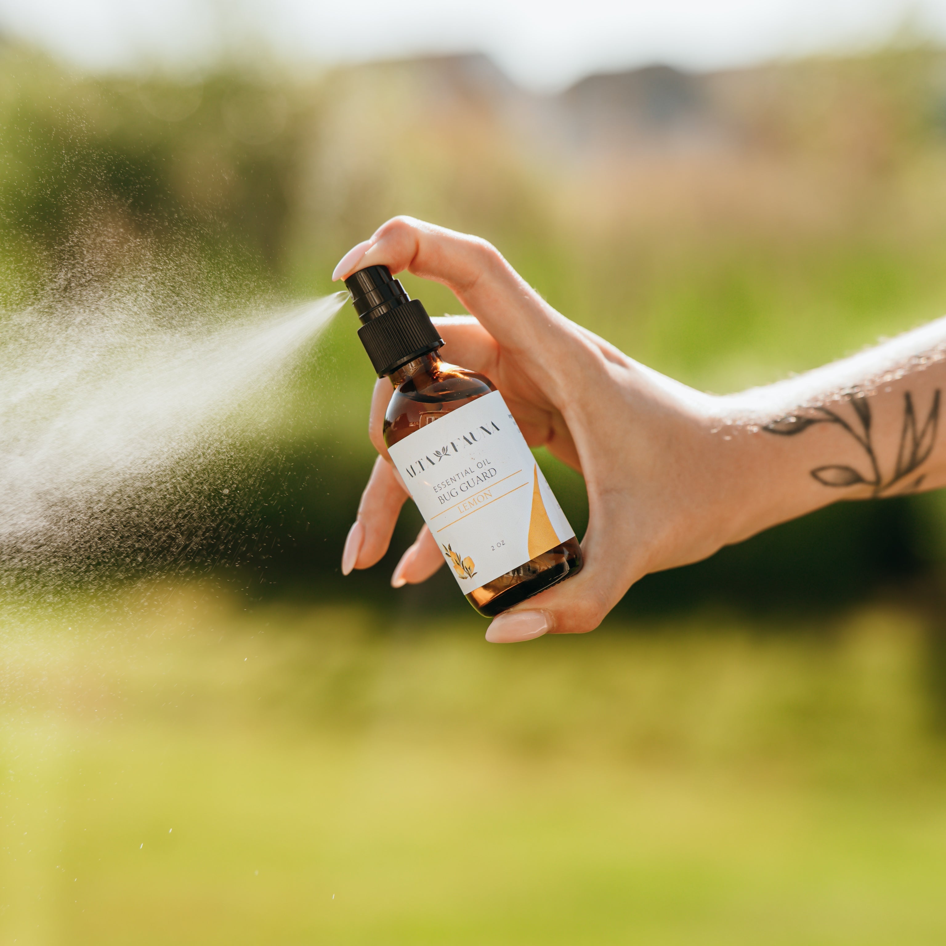 Alta Fauna Bug Guard natural insect repellent spray made with witch hazel and essential oils being sprayed outside, a fine mist is visible