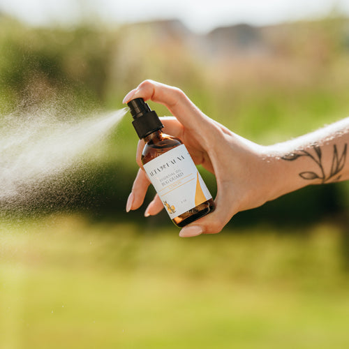 Alta Fauna Bug Guard natural insect repellent spray made with witch hazel and essential oils being sprayed outside, a fine mist is visible
