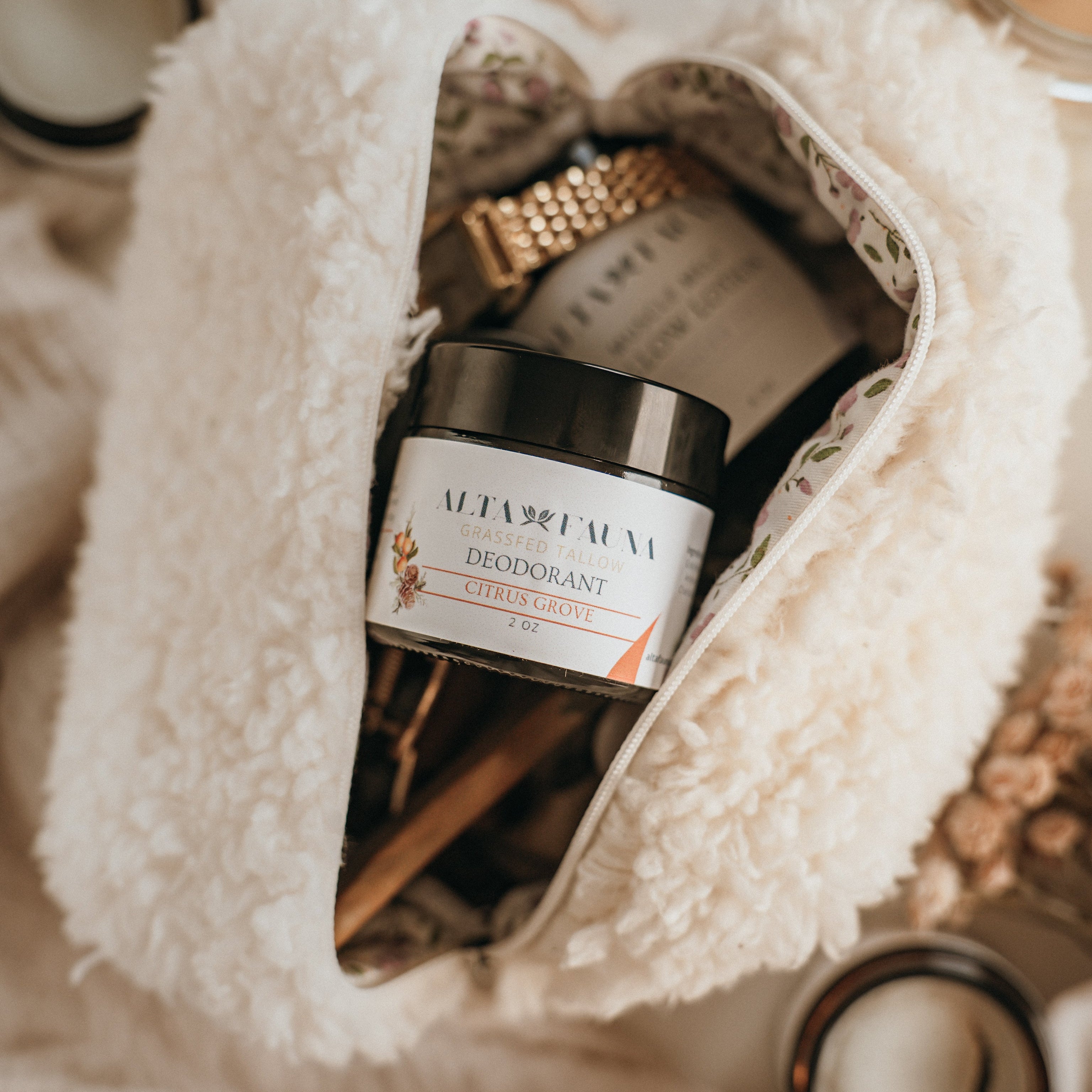Close up of Alta Fauna natural deodorant in a beauty bag. Alta Fauna deodorant jar made with grassfed beef tallow and essential oils for gentle daily freshness