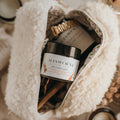 Close up of Alta Fauna natural deodorant in a beauty bag. Alta Fauna deodorant jar made with grassfed beef tallow and essential oils for gentle daily freshness