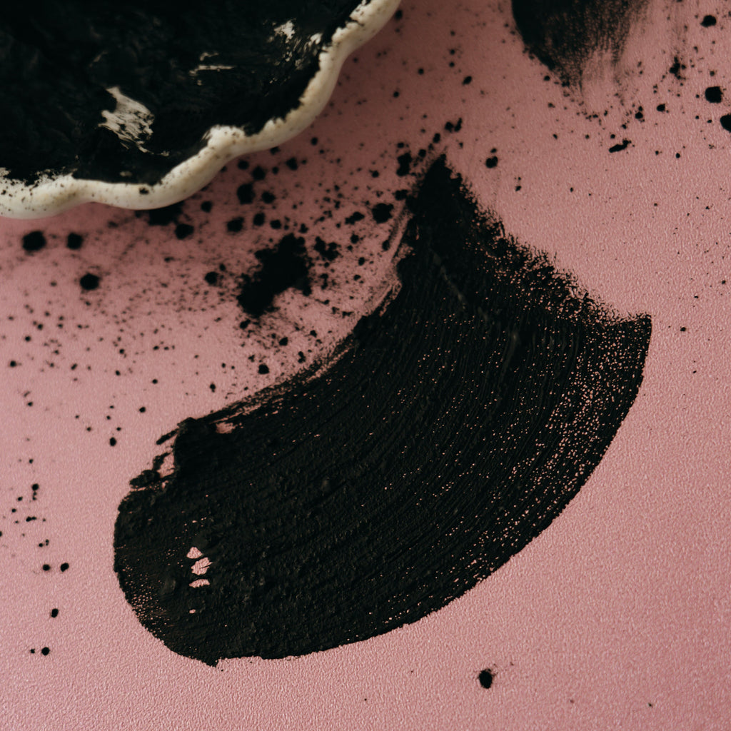 Smear of Alta Fauna moist face mask on pink background.