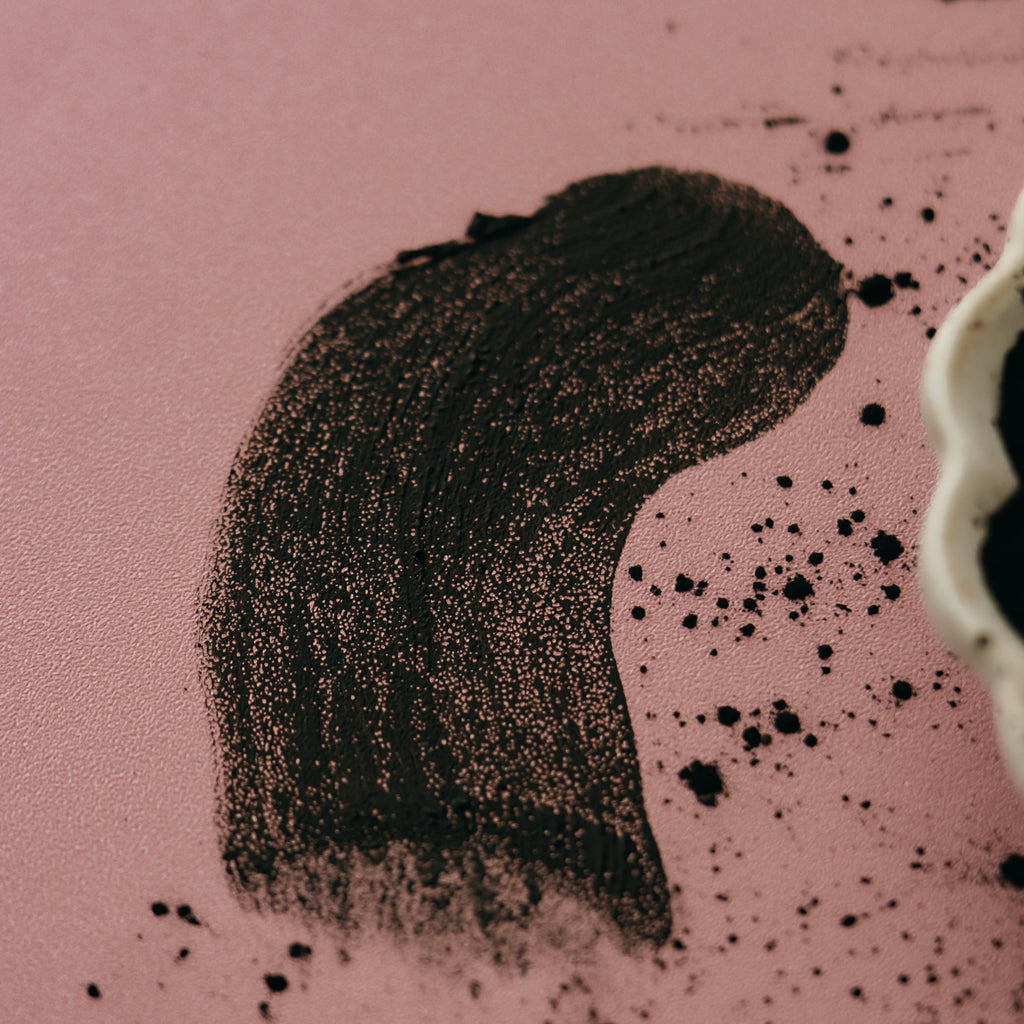Smear of Alta Fauna moist face mask on pink background.