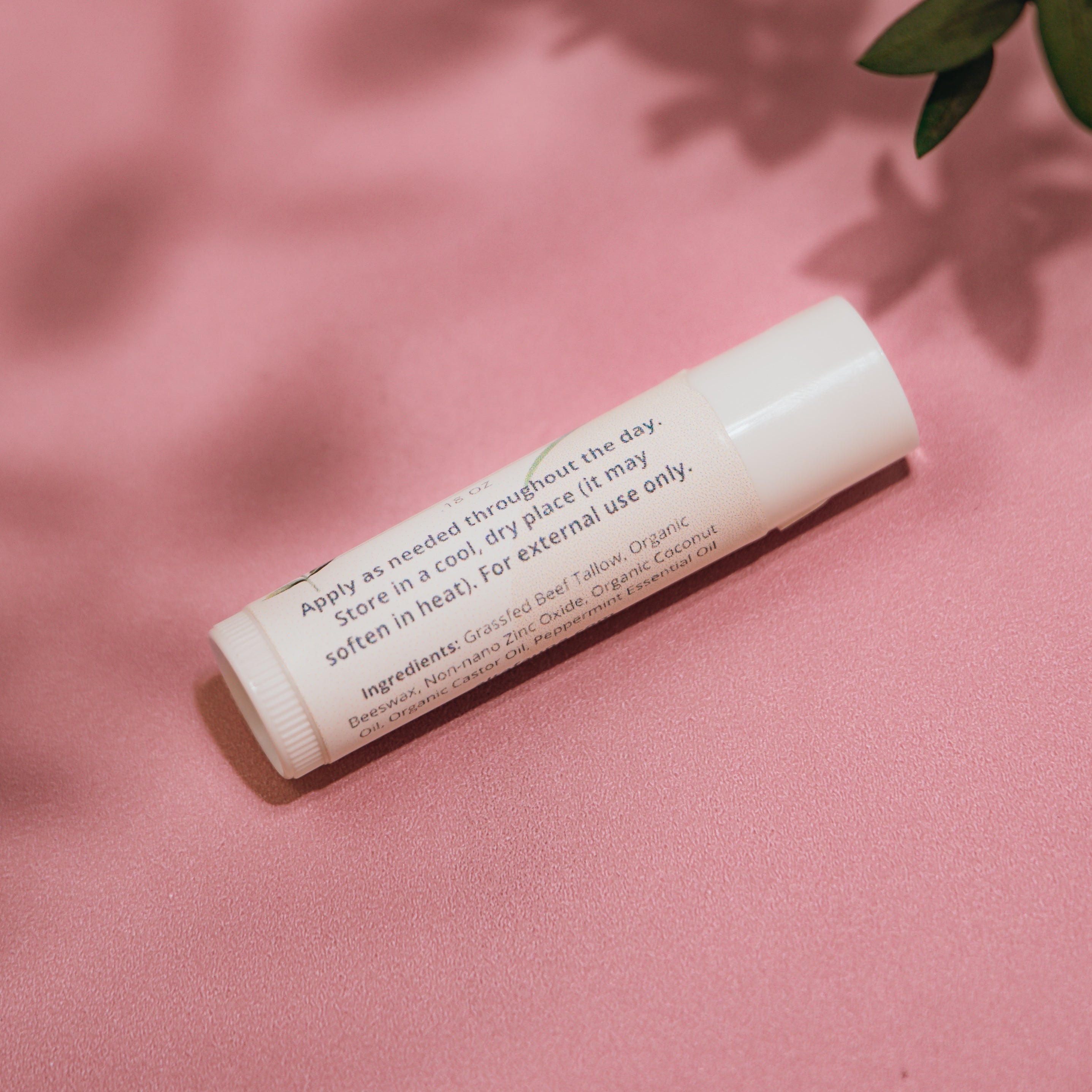 Close‑up of Alta Fauna Grassfed Tallow Lip Balm with mineral zinc for protective daily lip care. Close up of label and ingredients.