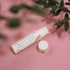 Close‑up of Alta Fauna Grassfed Tallow Lip Balm with mineral zinc for protective daily lip care. Shown in vanilla on a pink background.